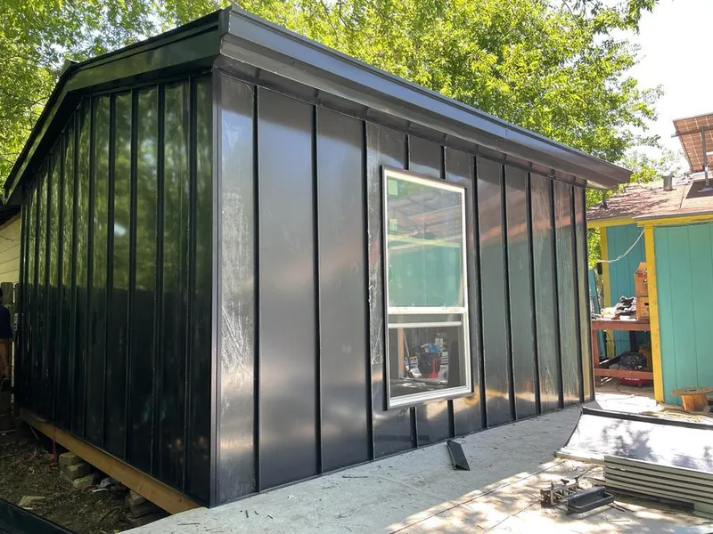 Black standing seam metal wall panels for Roof Inspection in DeWitt