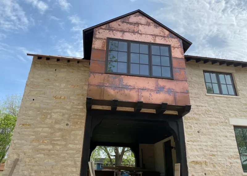 Copper metal panel facade on a stone building for Skylight Installation in DeWitt